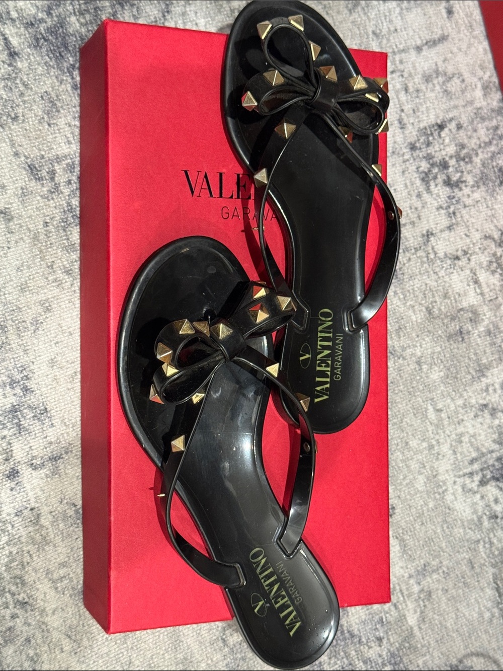 Valentino Garavani Black Jelly Bow Sandals with Gold Pyramid Studs